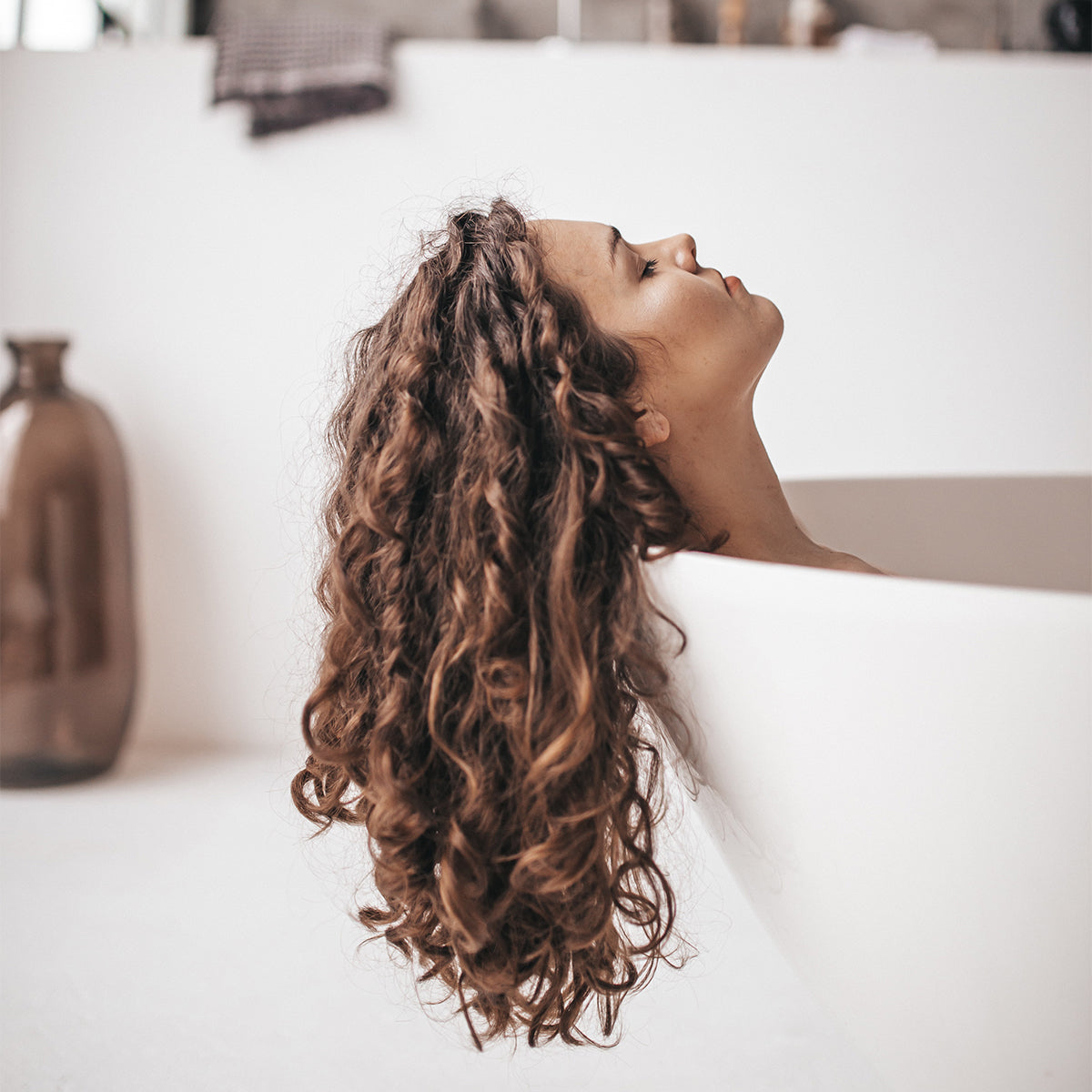 Woman with Curly Hair in Bathtub Relaxing